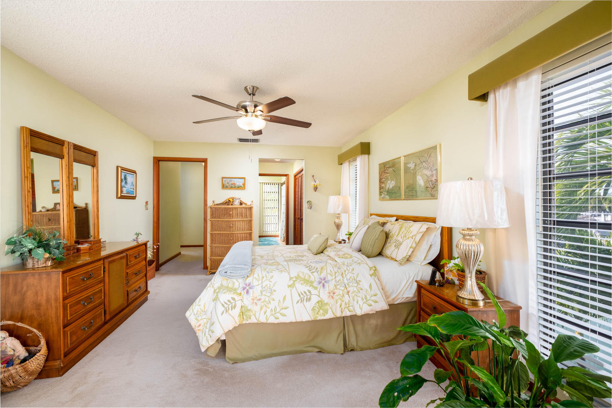 216 Sonny Road Tavernier, FL 33070 - Photo 20 of 49 a spacious bedroom with a bed and a chandelier