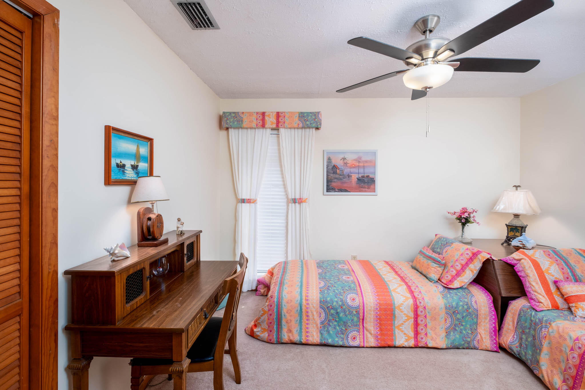216 Sonny Road Tavernier, FL 33070 - Photo 26 of 49 a bedroom with a bed and a chandelier