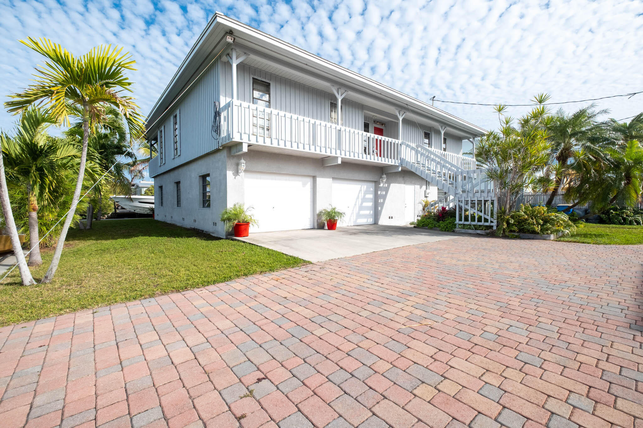 216 Sonny Road Tavernier, FL 33070 - Photo 32 of 49 a front view of a house with a yard and potted plants