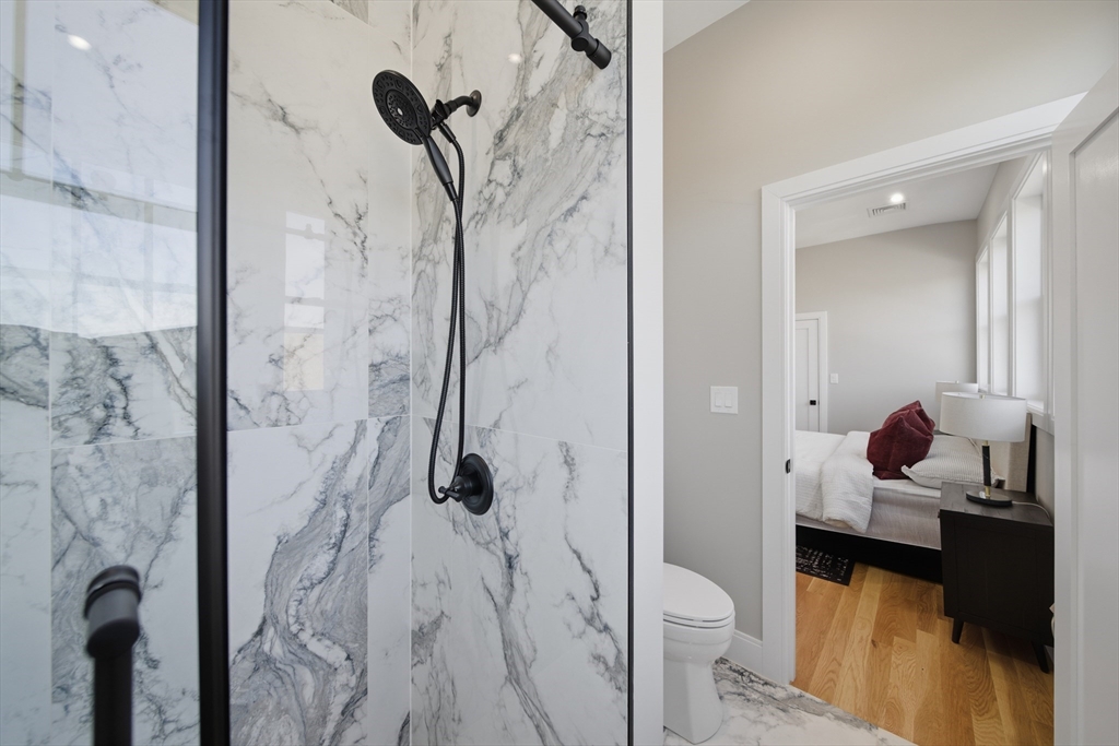 174 Walnut Street, Unit 3 Somerville, MA 02145 - Photo 12 of 38 a bathroom with a granite countertop shower a toilet and a sink