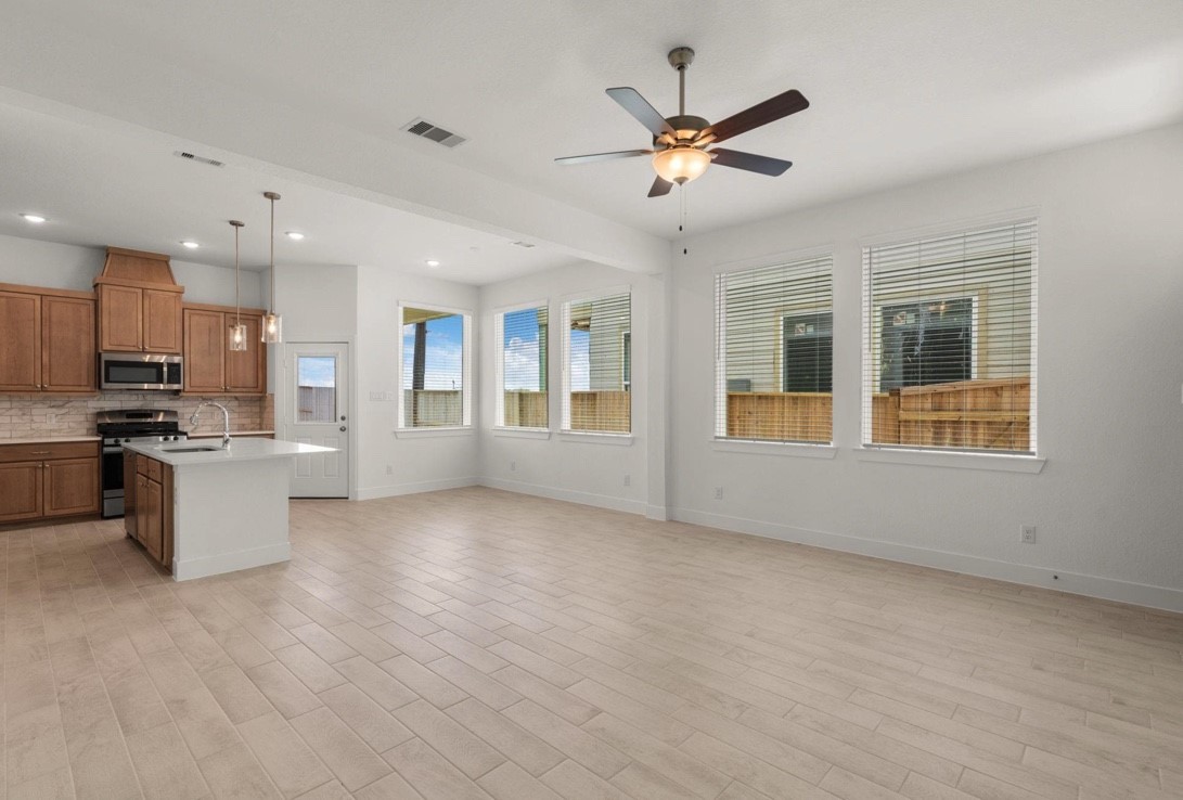 5234 Capricorn Way Manvel, TX 77578 - Photo 6 of 25 a view of an empty room with kitchen and window