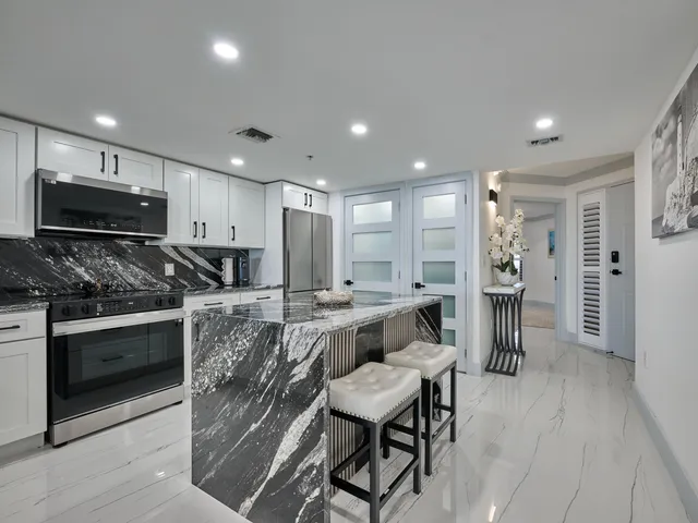 a kitchen with stainless steel appliances granite countertop a sink and cabinets