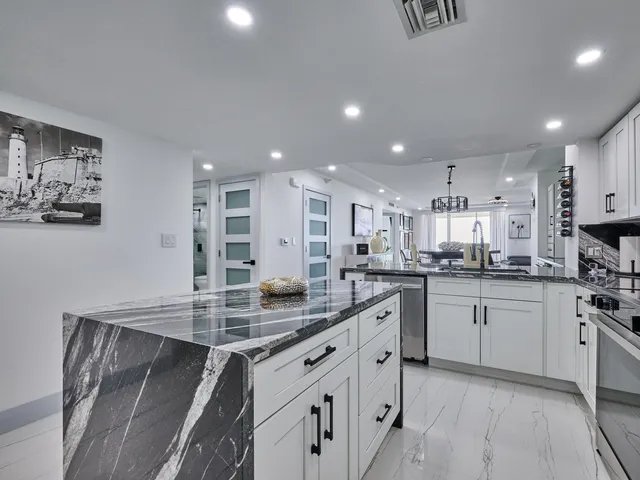 a spacious bedroom with a bed and a chandelier