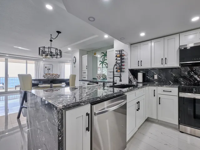 a room with a potted plant on the wall and a chair