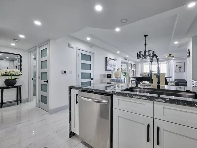 a bathroom with a double vanity sink toilet and shower