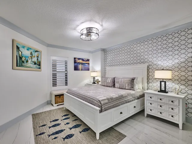 a living room with furniture a chandelier and a dining table