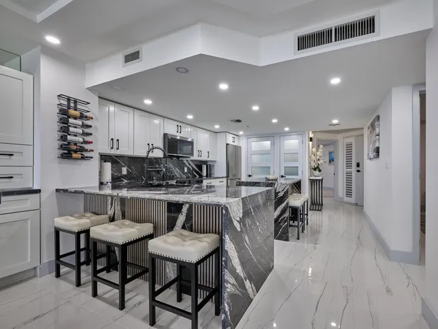 a living room with furniture and floor to ceiling windows