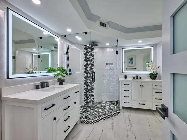 a view of a lake with a big yard and large trees