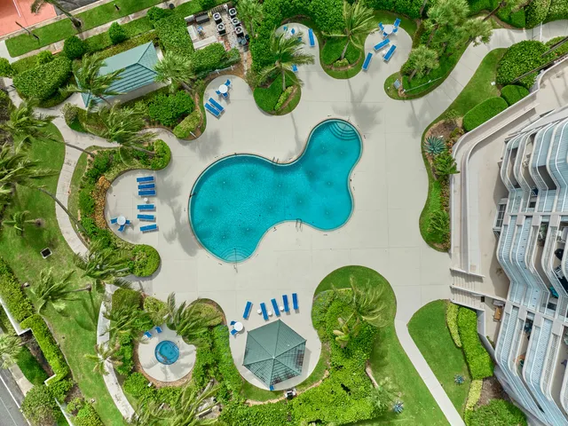 a view of a hallway with wooden floor and a living room