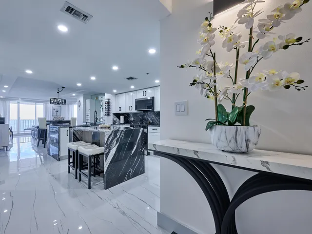 a kitchen with a refrigerator and a stove top oven with white cabinets