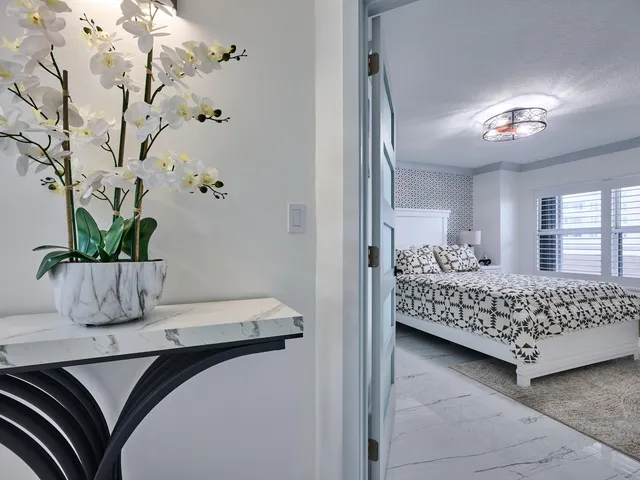 a kitchen with stainless steel appliances kitchen island granite countertop a stove a sink a refrigerator and a microwave