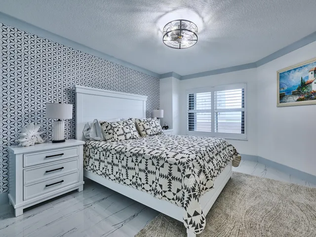 a kitchen with stainless steel appliances granite countertop a sink dishwasher a stove and white cabinets with wooden floor