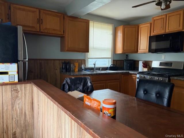 33 Eden Road, Unit 41 Cuddebackville, NY 12729 - Photo 22 of 34 a kitchen with stainless steel appliances wooden cabinets a stove a sink and a microwave