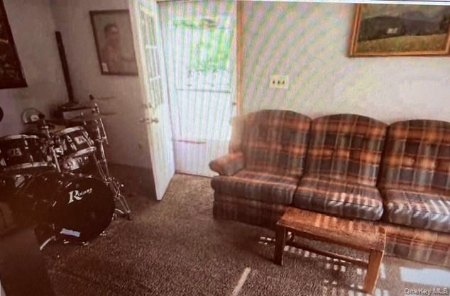 33 Eden Road, Unit 41 Cuddebackville, NY 12729 - Photo 31 of 34 a blue couch sitting in a living room next to a window