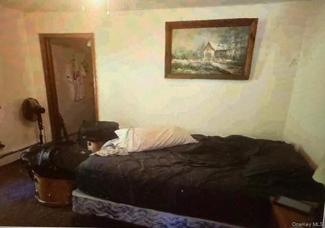 33 Eden Road, Unit 41 Cuddebackville, NY 12729 - Photo 32 of 34 a bed sitting in a bedroom next to a bathroom