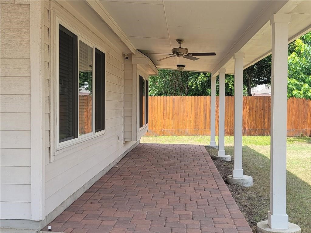 208 Hummingbird Lane Leander, TX 78641 - Photo 17 of 25 An inviting covered patio with brick pavers offers a perfect spot for outdoor enjoyment.