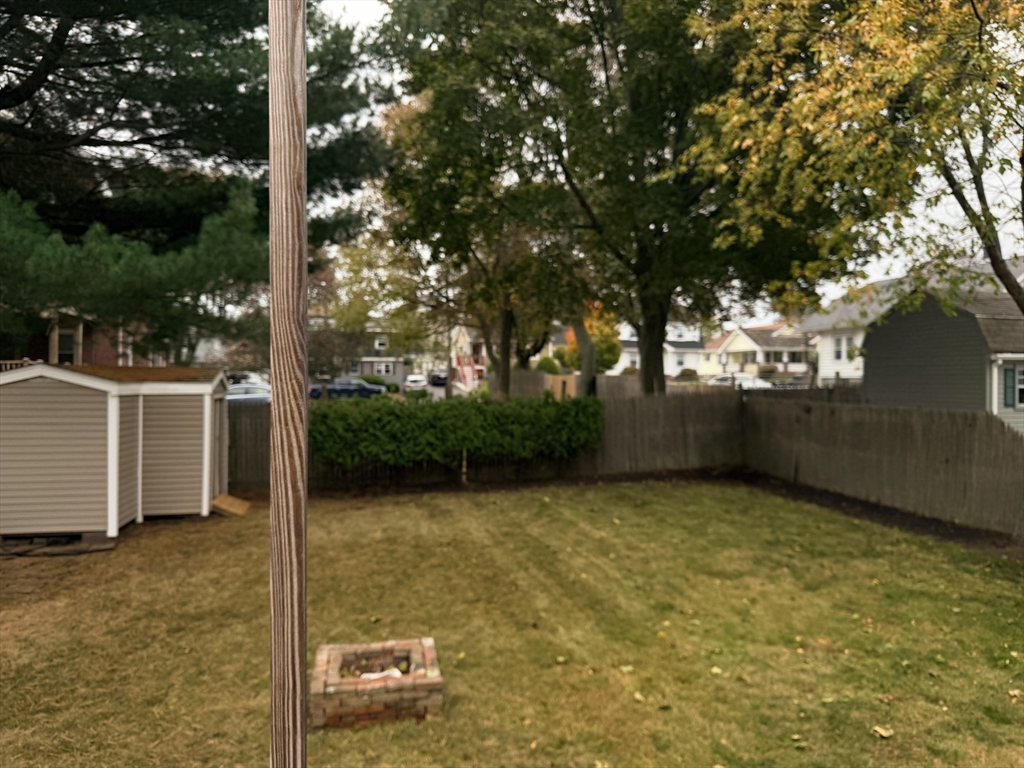 26 Colonial Road Peabody, MA 01960 - Photo 19 of 25 a view of a patio with table and chairs a barbeque and a large tree