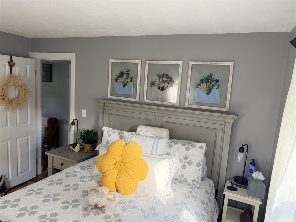 26 Colonial Road Peabody, MA 01960 - Photo 20 of 25 a bed room with a bed and painting on the wall
