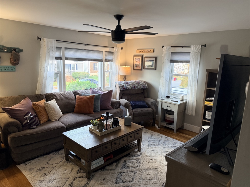 26 Colonial Road Peabody, MA 01960 - Photo 21 of 25 a living room with furniture a ceiling fan and a large window
