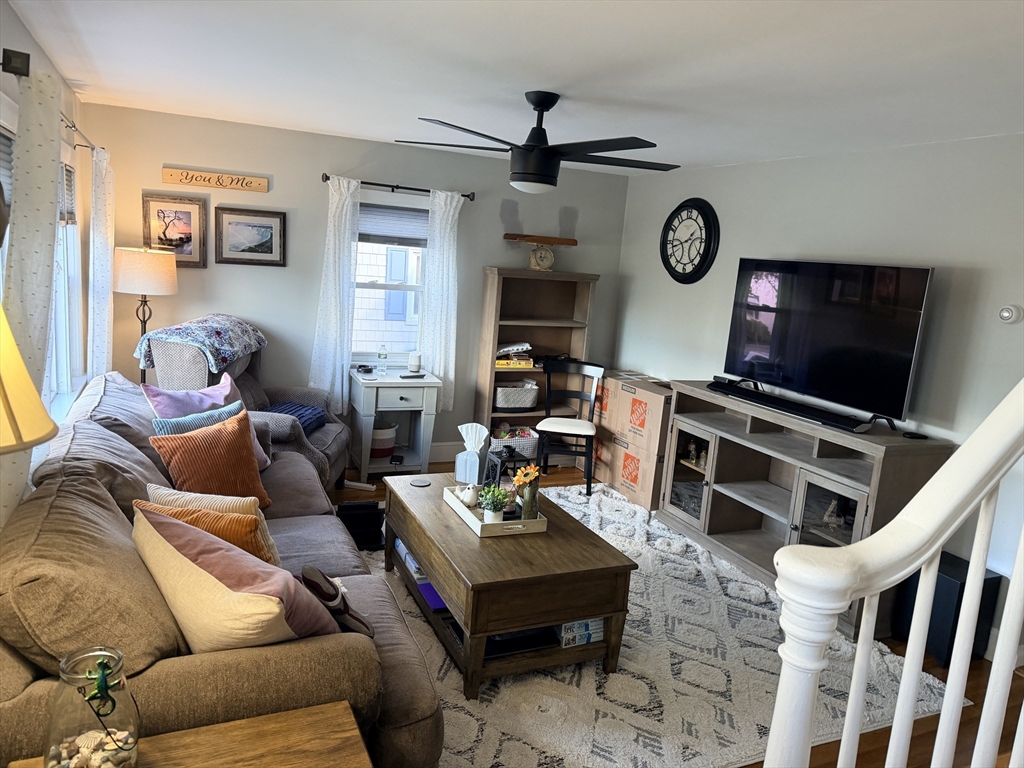 26 Colonial Road Peabody, MA 01960 - Photo 22 of 25 a living room with furniture a flat screen tv and a fireplace