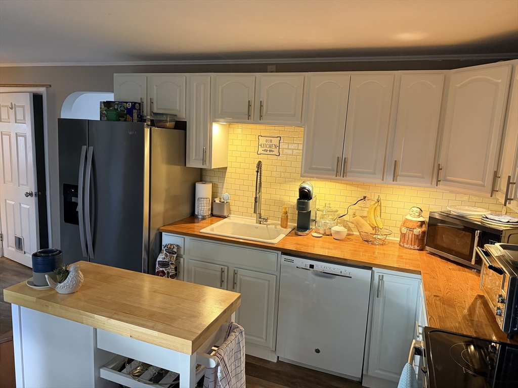 26 Colonial Road Peabody, MA 01960 - Photo 7 of 25 a kitchen with a sink and cabinets