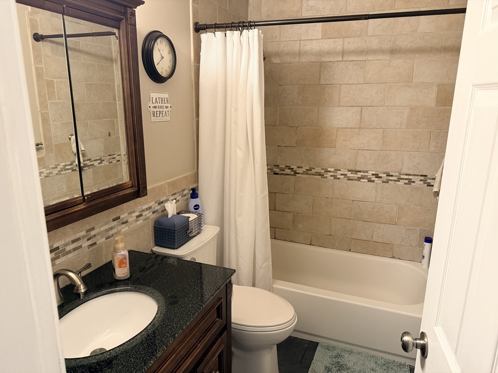 26 Colonial Road Peabody, MA 01960 - Photo 8 of 25 a bathroom with a sink a toilet and shower