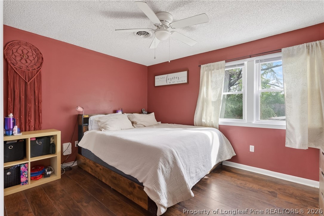 1083 Strickland Bridge Road Fayetteville, NC 28304 - Photo 11 of 25 a bedroom with a bed bookshelf and a window