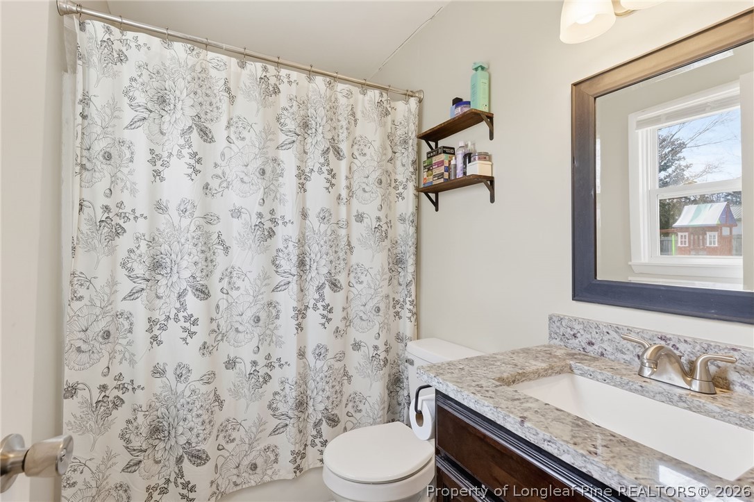 1083 Strickland Bridge Road Fayetteville, NC 28304 - Photo 12 of 25 a bathroom with a granite countertop sink toilet and shower