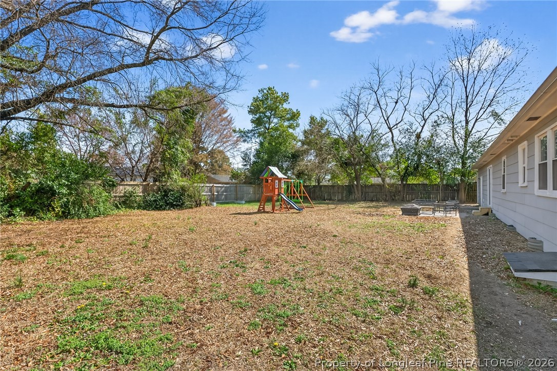 1083 Strickland Bridge Road Fayetteville, NC 28304 - Photo 17 of 25 a backyard of a house with a yard and outdoor seating