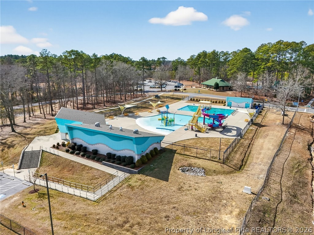 1083 Strickland Bridge Road Fayetteville, NC 28304 - Photo 24 of 25 a view of swimming pool with outdoor seating and a garden