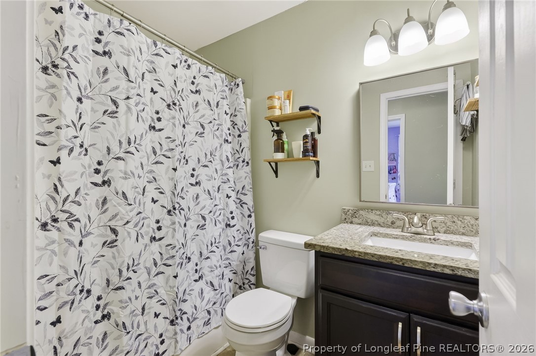 1083 Strickland Bridge Road Fayetteville, NC 28304 - Photo 9 of 25 a bathroom with a sink and a toilet