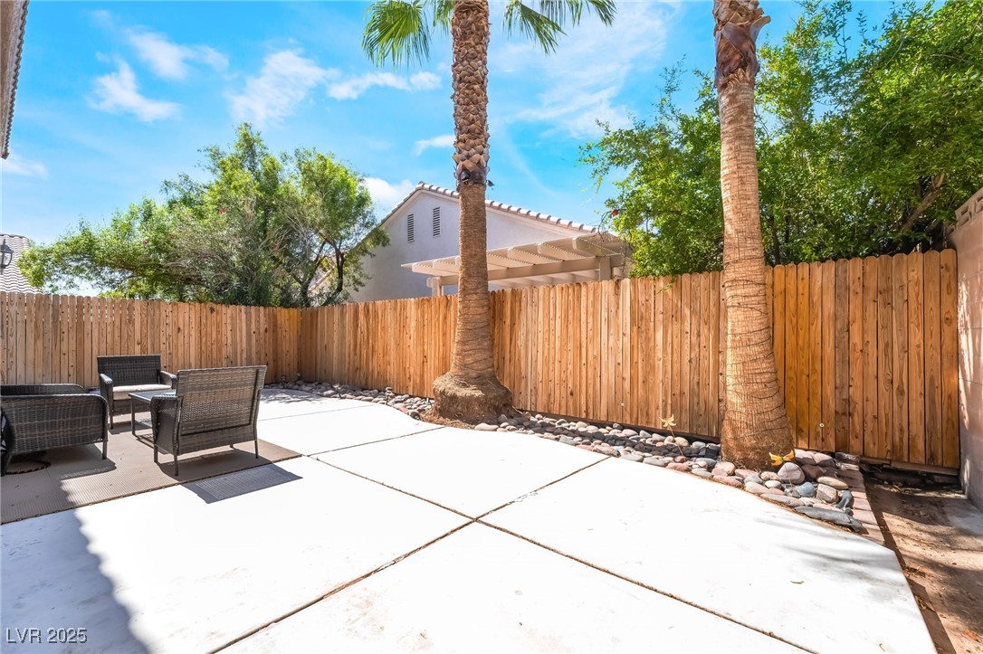 5322 Runningbrook Road Las Vegas, NV 89120 - Photo 24 of 25 Fenced backyard featuring a patio area and outdoor lounge area