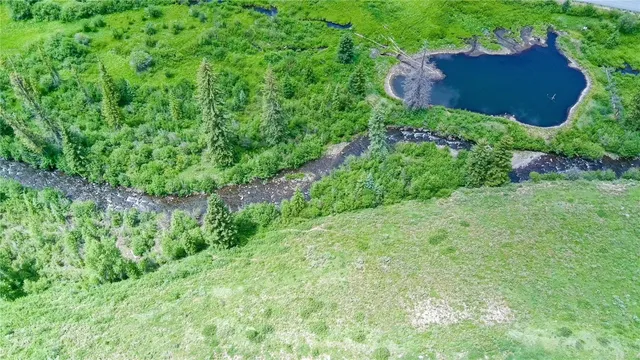 an aerial view of a house with a garden and yard