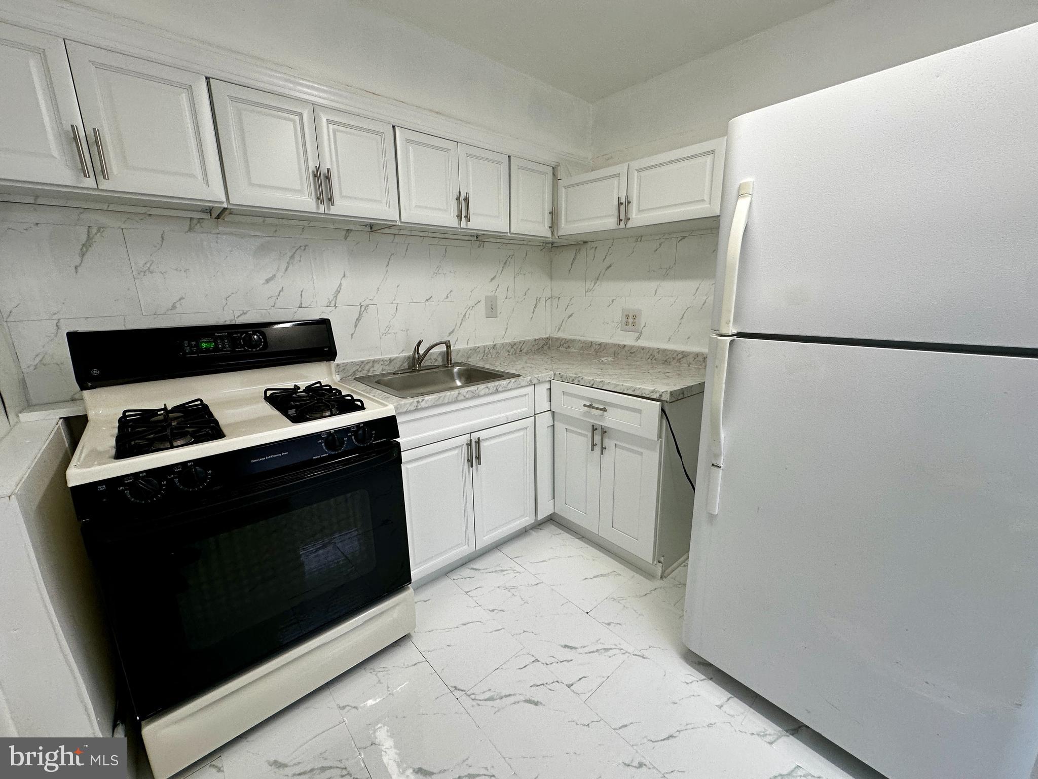 3236 Guilford Street, Unit 2 Philadelphia, PA 19136 - Photo 3 of 10 a kitchen with a stove sink and refrigerator