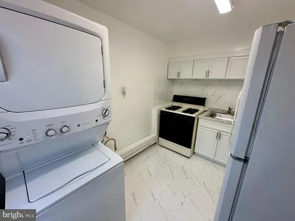 a kitchen with a stove top oven and cabinets