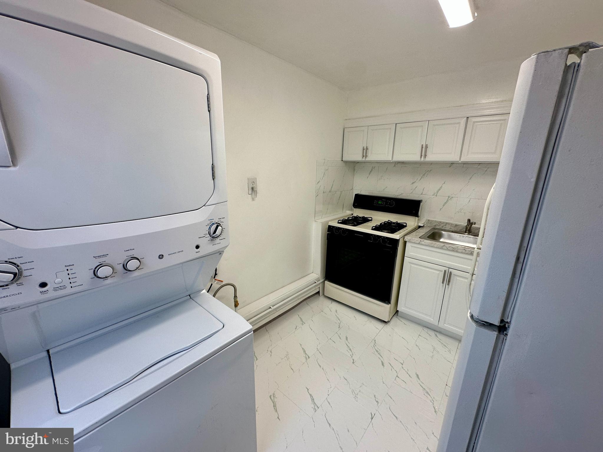 3236 Guilford Street, Unit 2 Philadelphia, PA 19136 - Photo 4 of 10 a kitchen with a stove top oven and cabinets