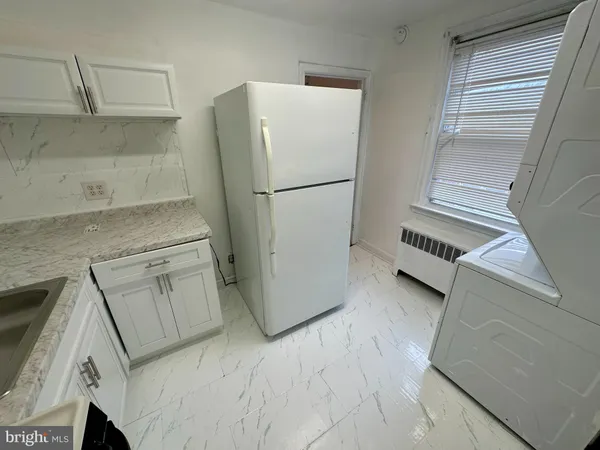 a refrigerator freezer sitting inside of a kitchen