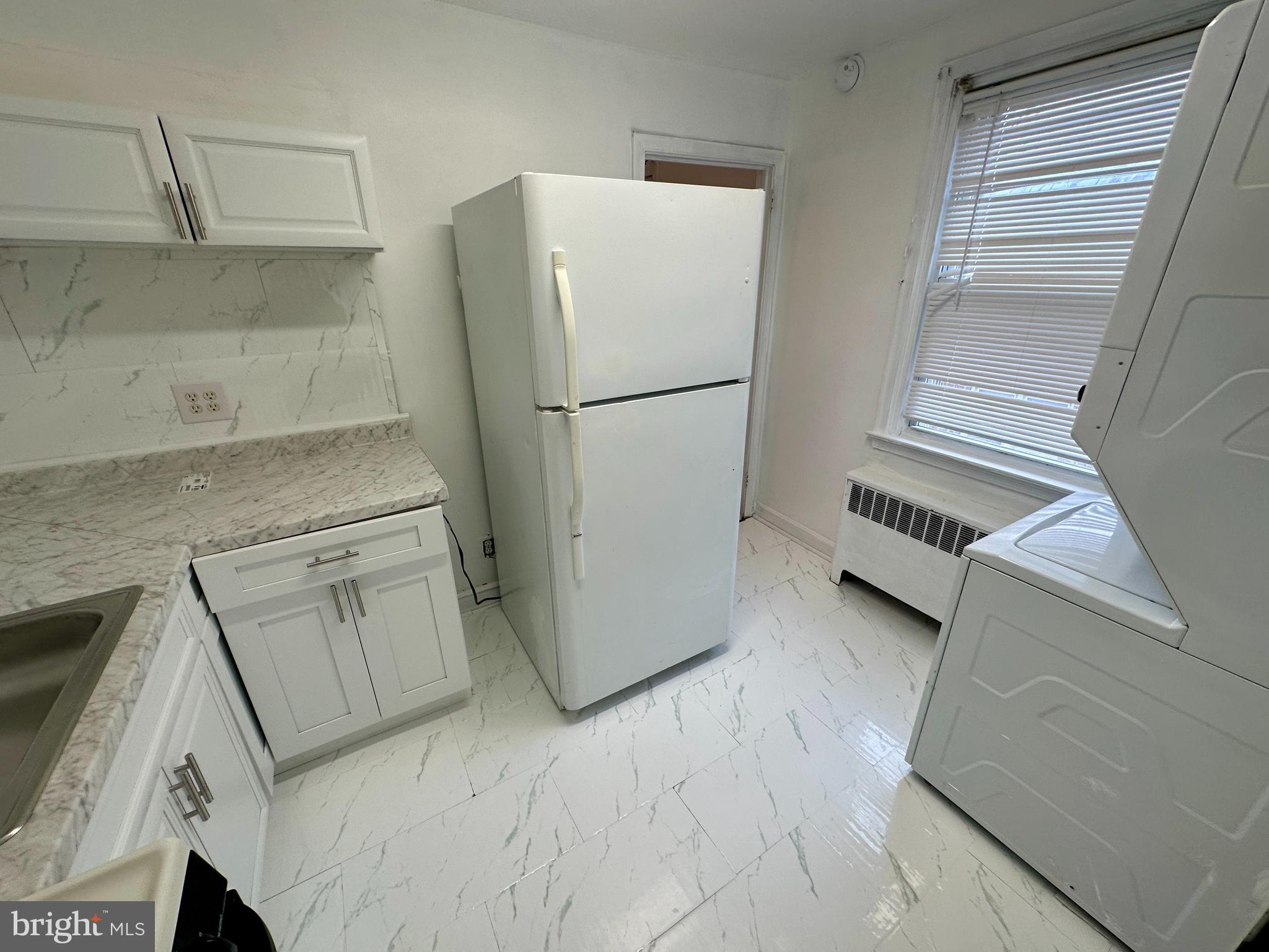 3236 Guilford Street, Unit 2 Philadelphia, PA 19136 - Photo 5 of 10 a refrigerator freezer sitting inside of a kitchen