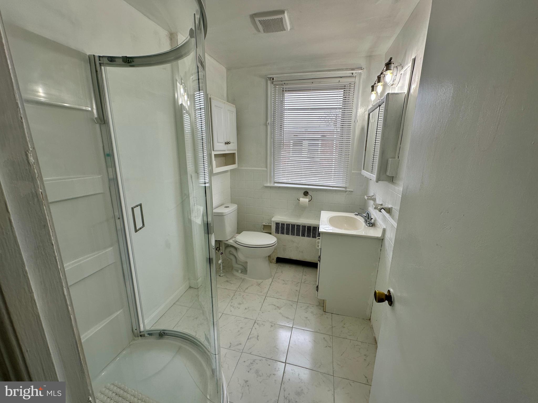 3236 Guilford Street, Unit 2 Philadelphia, PA 19136 - Photo 8 of 10 a bathroom with a sink toilet and shower