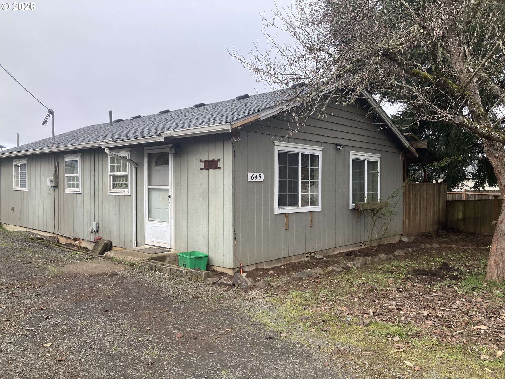 645 South 14th Street Cottage Grove, OR 97424 - Photo 13 of 15 a house with trees in the background