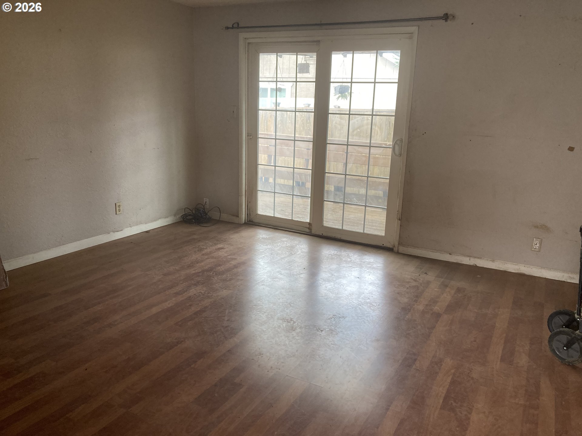 645 South 14th Street Cottage Grove, OR 97424 - Photo 2 of 15 a view of an empty room with wooden floor and a window