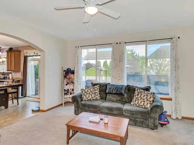 a kitchen with a stove a refrigerator a sink dishwasher a dining table and chairs with wooden floor