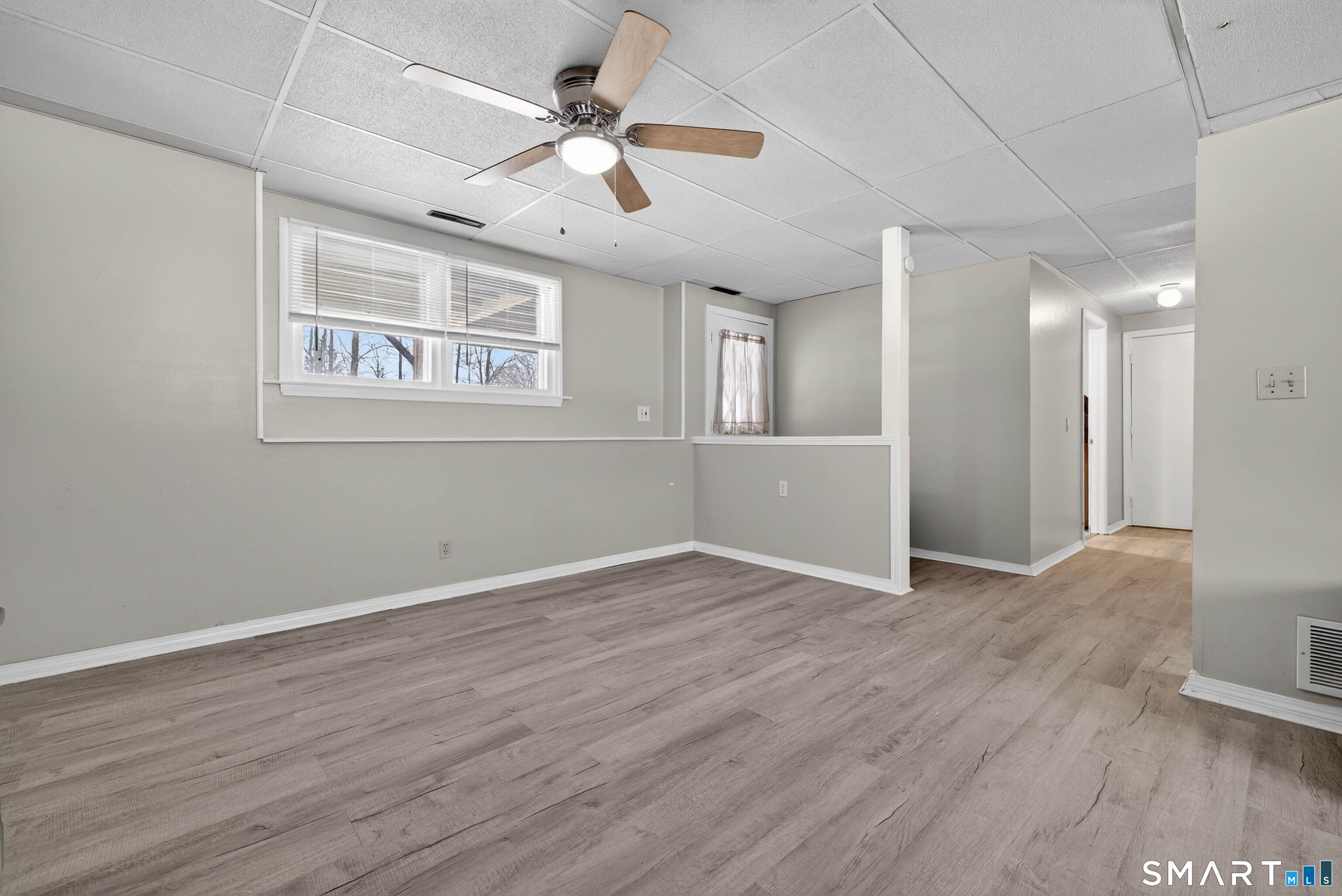 63 Spice Hill Drive Meriden, CT 06451 - Photo 19 of 30 a view of an empty room with wooden floor and a ceiling fan