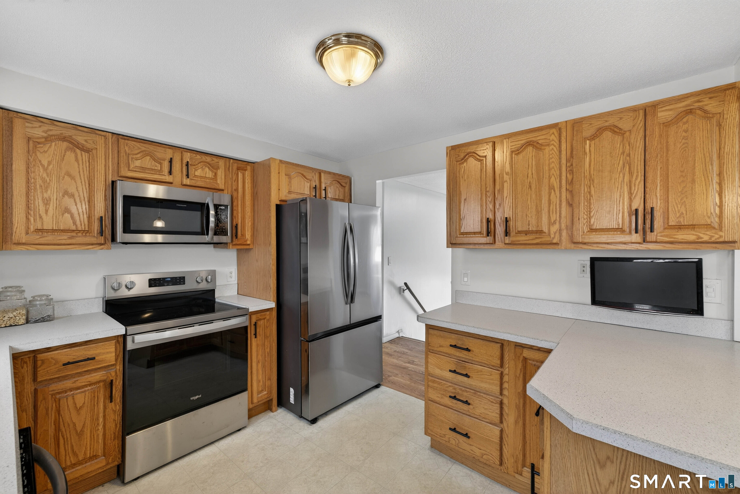 63 Spice Hill Drive Meriden, CT 06451 - Photo 4 of 30 a kitchen with stainless steel appliances a stove microwave and refrigerator