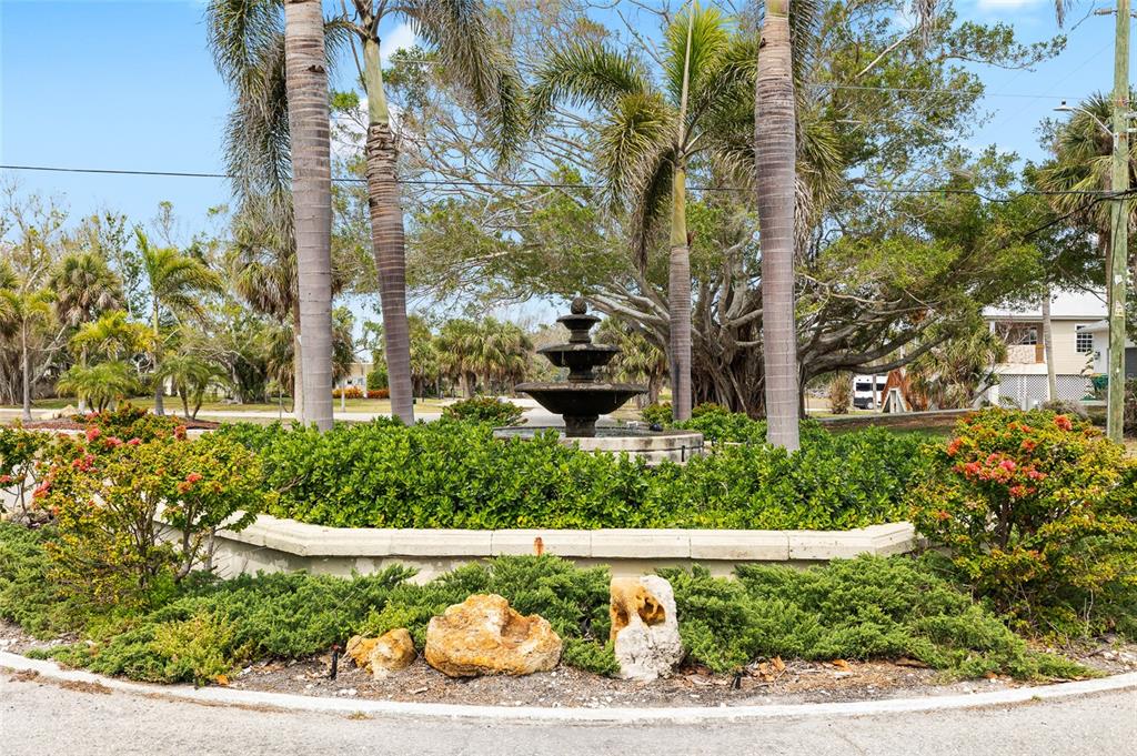 70 Spaniards Road Placida, FL 33946 - Photo 14 of 21 a view of a garden with a fountain and plants