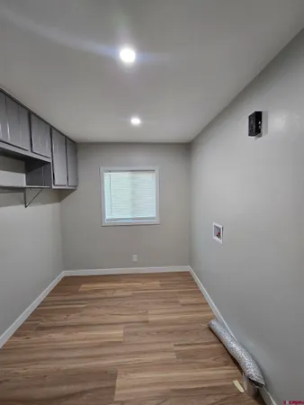 a view of a room with wooden floor and window