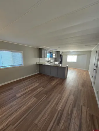 a room with wooden floor and window