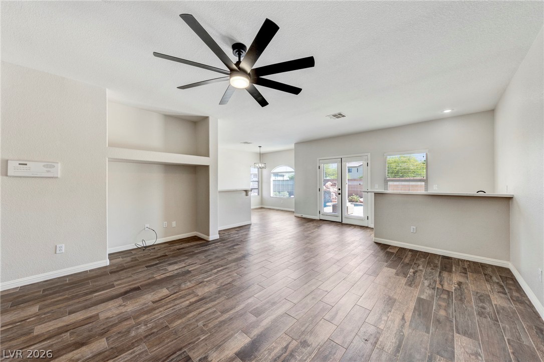 740 Aldo Rae Court, Unit NONE Henderson, NV 89052 - Photo 9 of 35 An open concept living area features resilient wood-look tile flooring and a sleek ceiling fan.