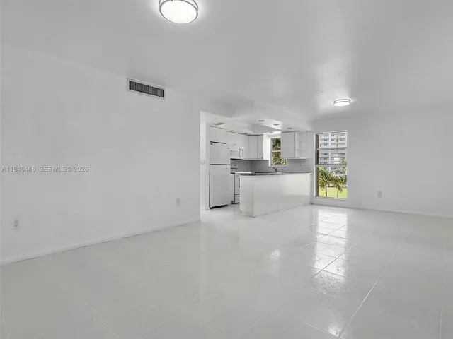 a view of a kitchen with a sink and dishwasher a refrigerator with wooden floor