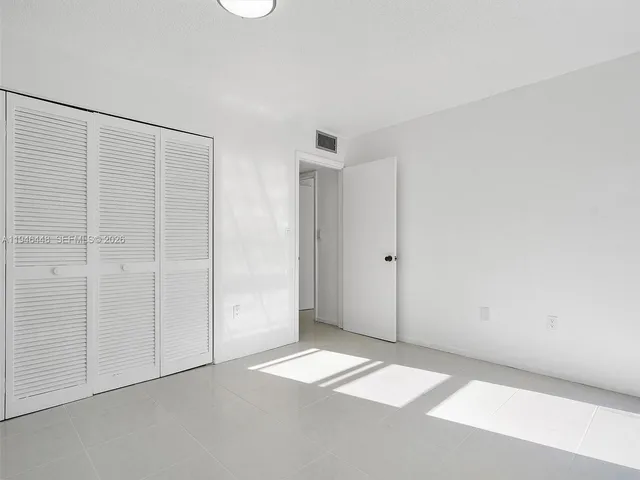 a view of a hallway with wooden shelves